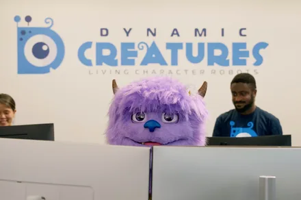 Hugo is fluffy, purple, and ready to steal your next theme park selfie. And oh! Hugo is a robot